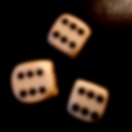 Blurred  image of 3 dices showing 666 